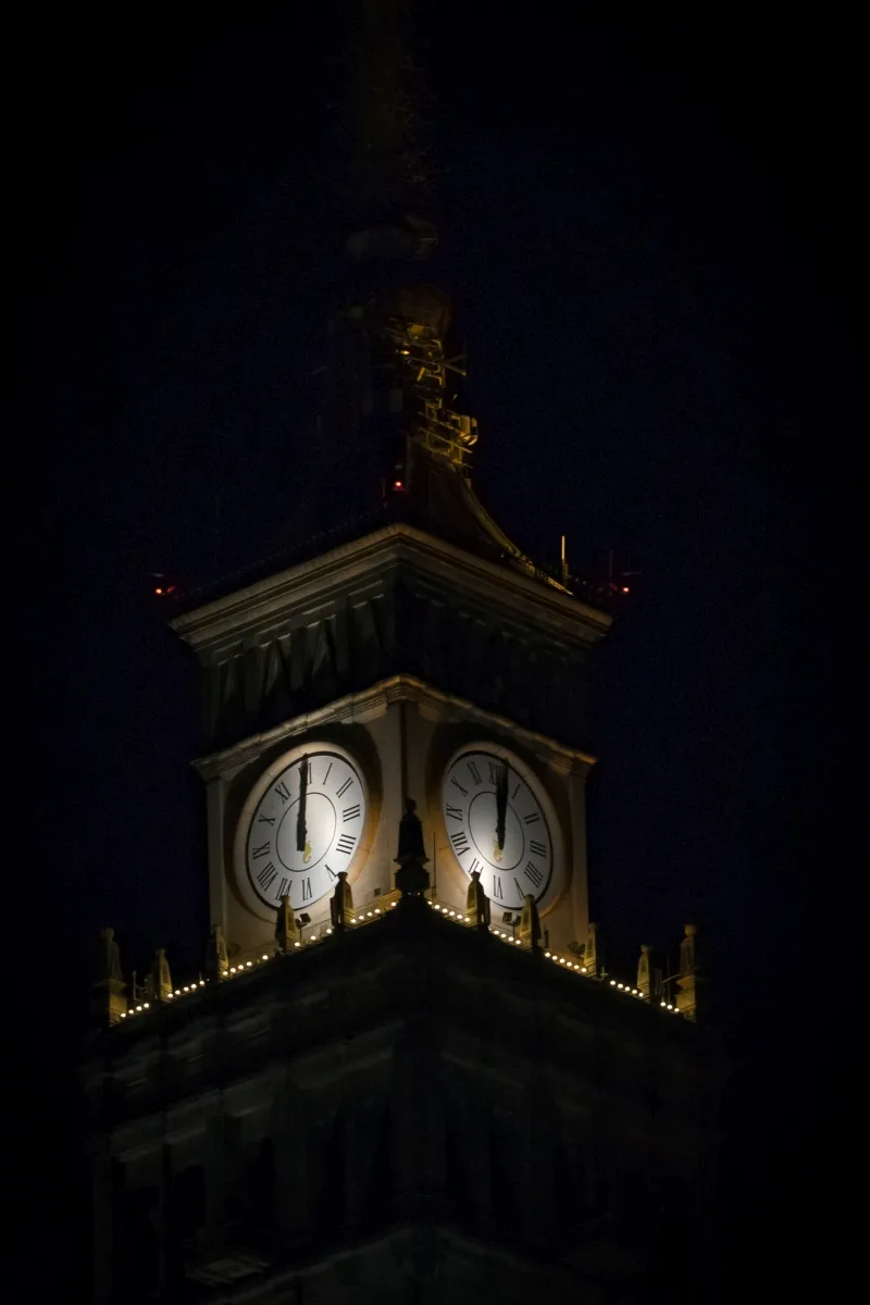 Illuminated clock faces of the Palace of Culture and Science at night